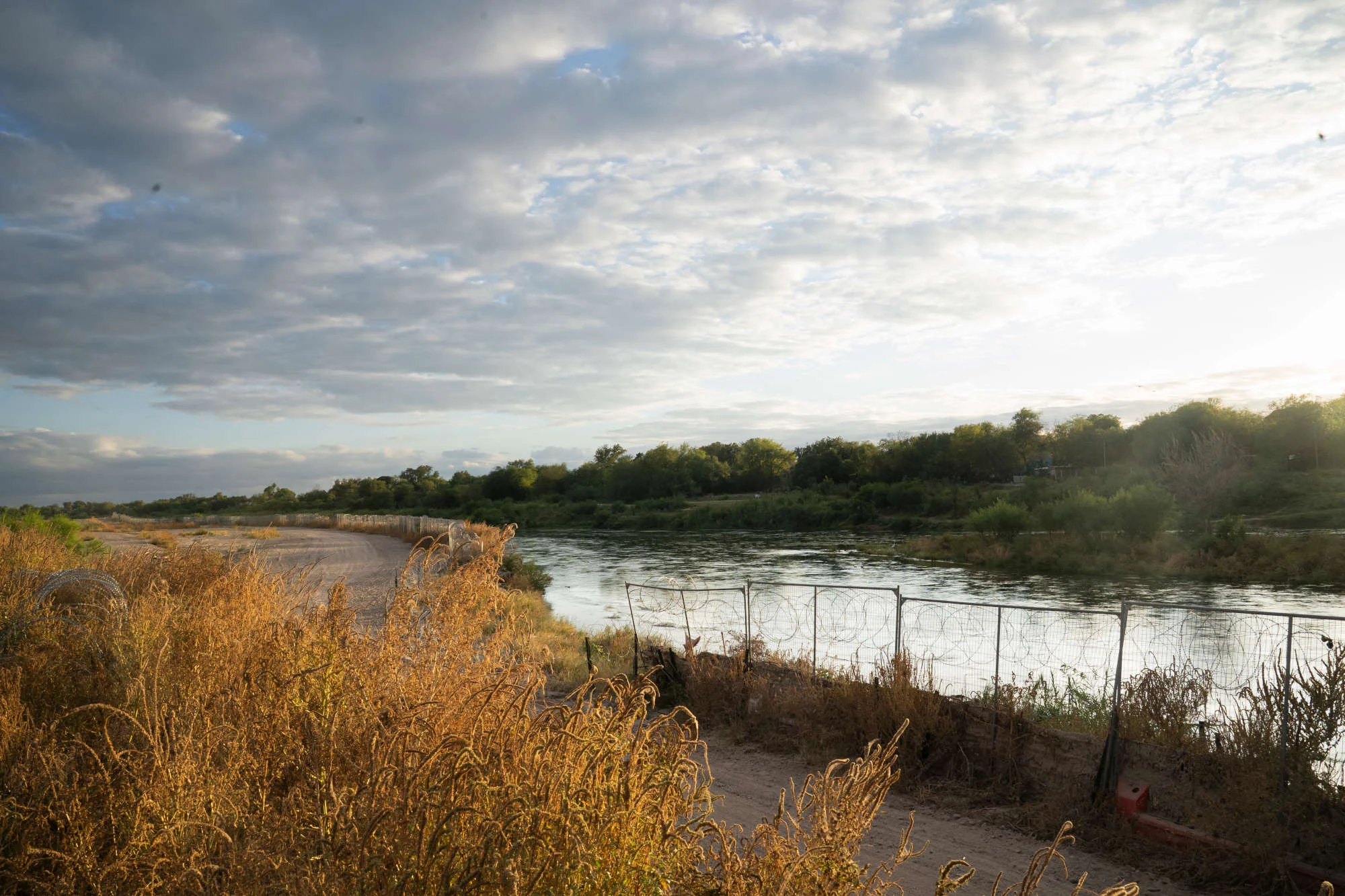 A walking path by a river.