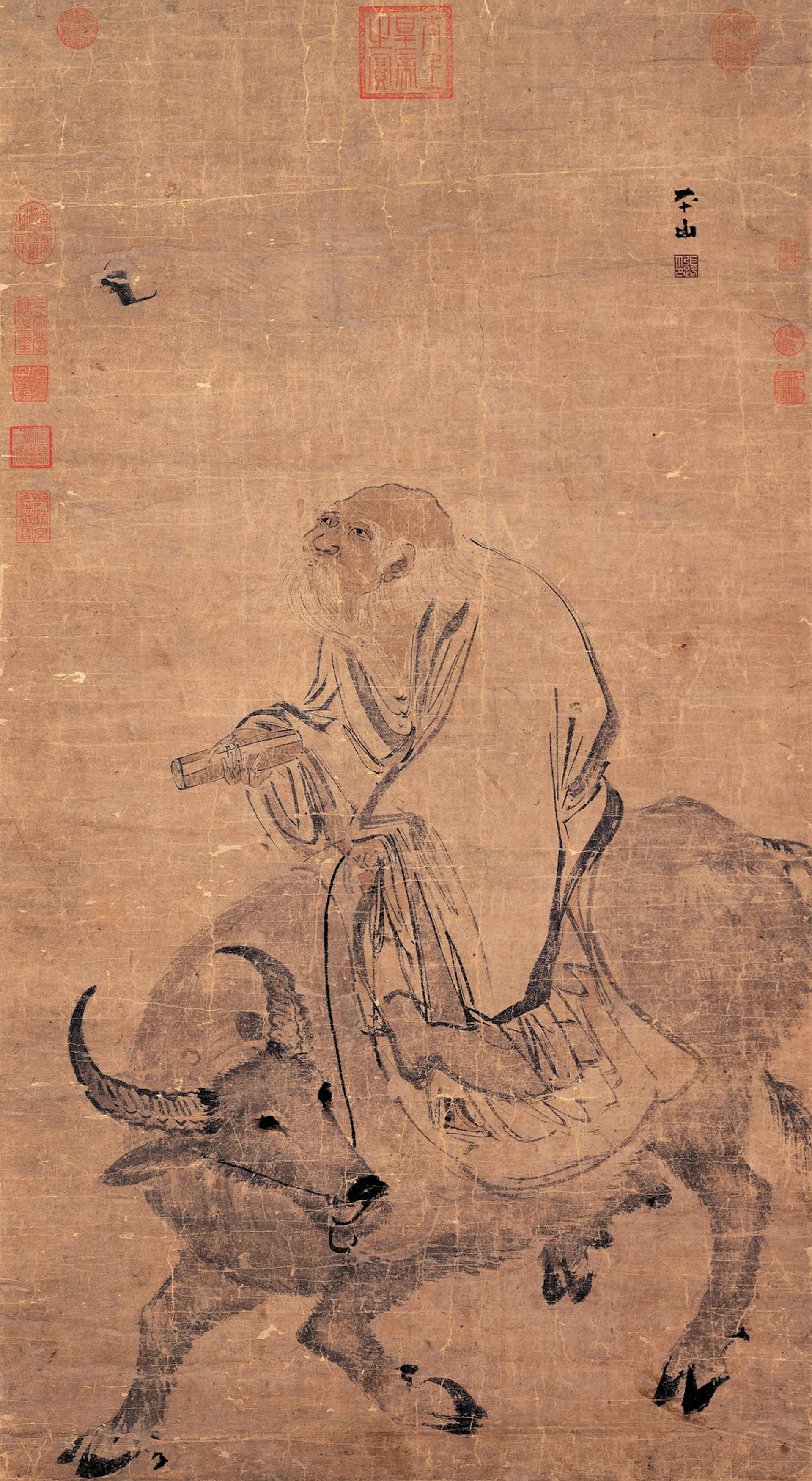 A faded scroll with a bit of Chinese script shows an elderly man in a robe sitting on top of an ox.