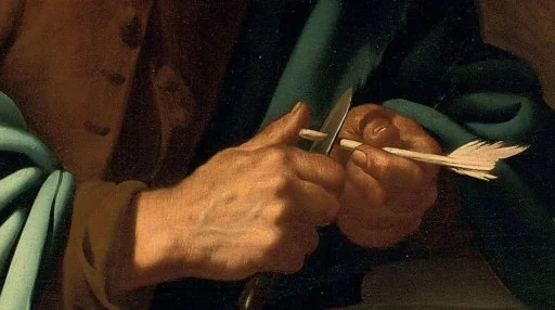 A close-up of two hands carving a feathered arrow shaft with a knife against a dark background.