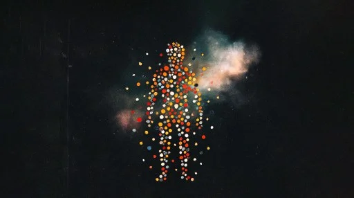 Silhouette of a human figure made up of colorful dots with a cloud-like mist behind it, set against a dark background.